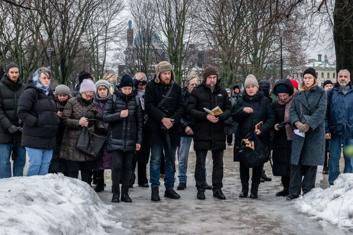People read a civil memorial service to victims of political repression to honour the memory of Russian opposition leader Alexei Navalny the day after the news of his death, in St. Petersburg.