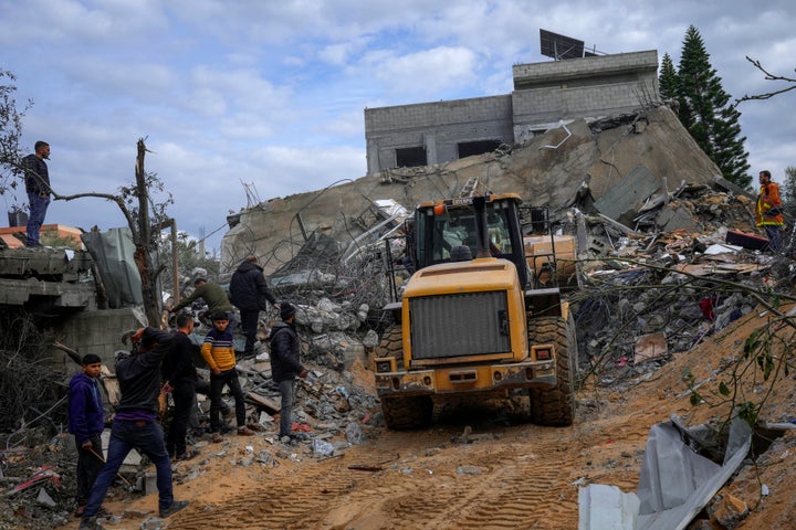 Palestinians search for survivors after an Israeli airstrike on a residential building in Al Zawayda, central Gaza Strip, on Sunday.