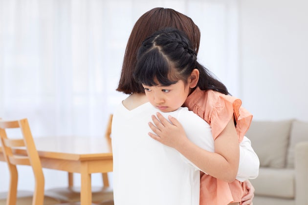 Japanese mother hugging daughter