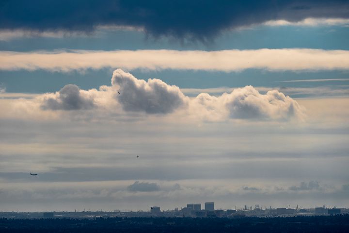 A plane descends into Los Angeles International Airport as low clouds gather over the Pacific ahead of forecasted rain in Los Angeles, on Feb. 18, 2024.