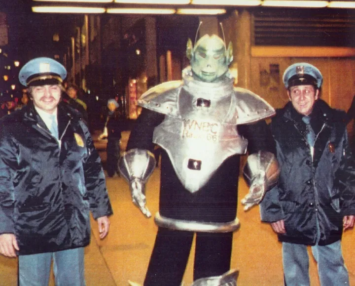 Quando Lee Speigel começou o programa "Edge of Reality" da NBC Radio em 1982, inicialmente ele foi anunciado apenas como "O Alien" como uma manobra promocional. Seu traje foi projetado pela mesma equipe que criou os esquetes dos "Coneheads" no "Saturday Night Live". CORTESIA DE LORRAINE SIMONE