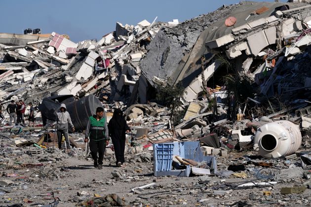 Palestinians visit their houses destroyed in the Israeli bombings in Al-Zahra, on the outskirts of Gaza City, on Thursday, Nov. 30, 2023.