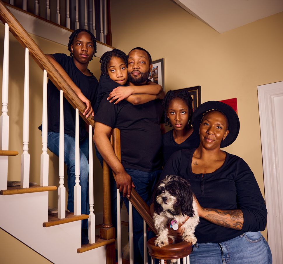 Dr. Jenn M. Jackson and Daren W. Jackson pose for a portrait with their family in their home in Syracuse, New York. Pictured from left are Logan, Jaelen, Daren, Camryn, Jenn and their dog Domino.