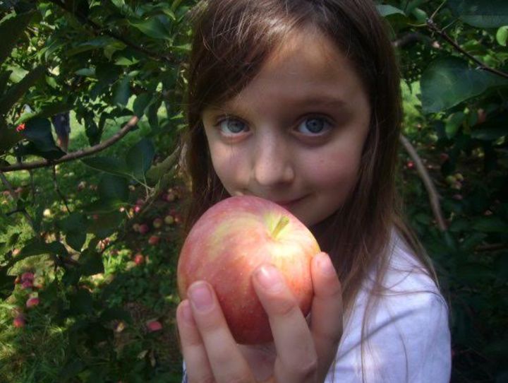 Ana at age 8, during a day of apple picking.