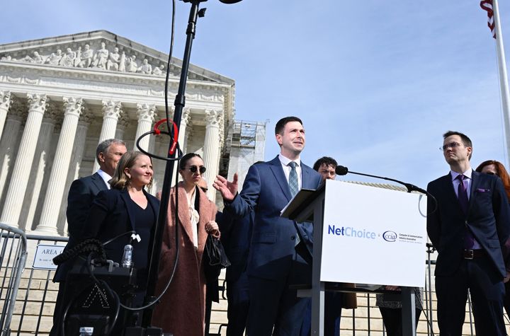 Chris Marchese (center), director of NetChoice Litigation Center, speaks to the news media Monday outside the U.S. Supreme Court.