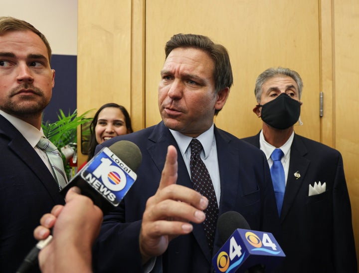 Florida Gov. Ron DeSantis responds to a TV reporter's question on May 24, 2021, after he signed legislation to make it harder for social media companies to punish users who violate terms of service agreements.