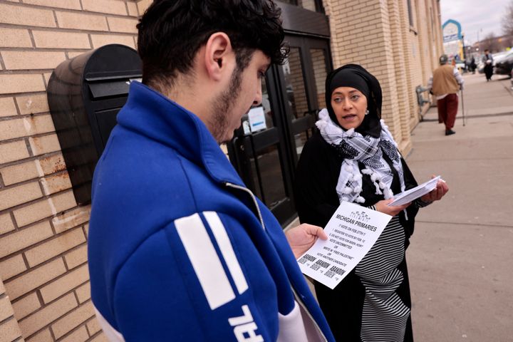 Samra'a Luqman, right, hands out fliers outside a Dearborn Heights mosque on Feb. 16, urging worshipers to vote "uncommitted" in the Democratic presidential primary.