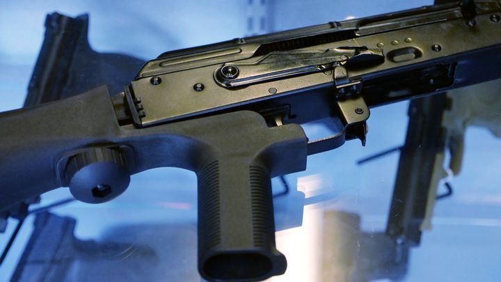 A bump stock is shown being attached to a semi-automatic rifle at the Gun Vault store and shooting range in South Jordan, Utah. Bump stocks were banned in response to the October 2017 mass shooting in Las Vegas.