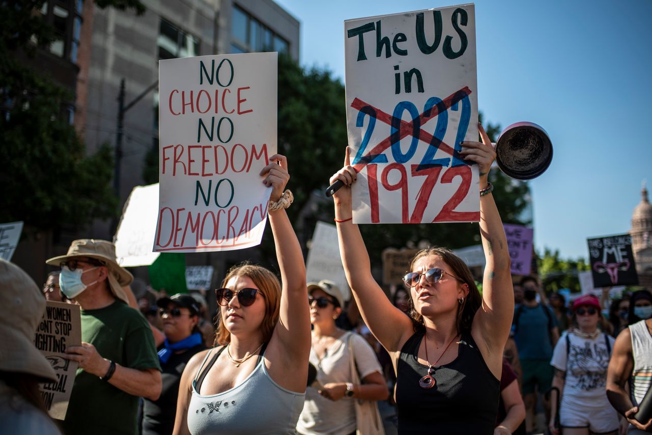 Protesters march while holding signs during an abortion rights rally on June 25, 2022, in Austin, Texas, after the Supreme Court repealed Roe v. Wade.