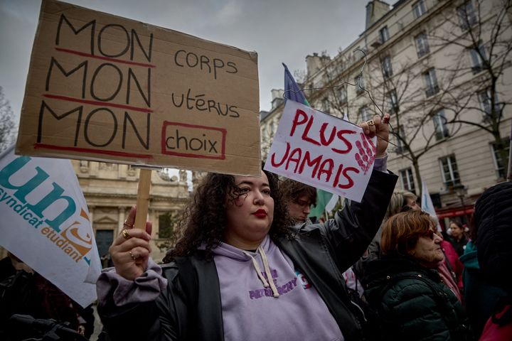 Protestors hold a slogan which reads "My body, My uterus, My choice" during a silent gathering at Place de la Sorbonne organised by 'Abortion in Europe' movement, within a vote of a bill to enshrine the guaranteed freedom of abortion for women in the constitution, in Paris on February 28, 2024. France's lower-house National Assembly overwhelmingly voted in favour of the measure as a "guaranteed freedom" in late January, with almost all members of Macron's centrist minority coalition as well as left-wing opposition parties approving.