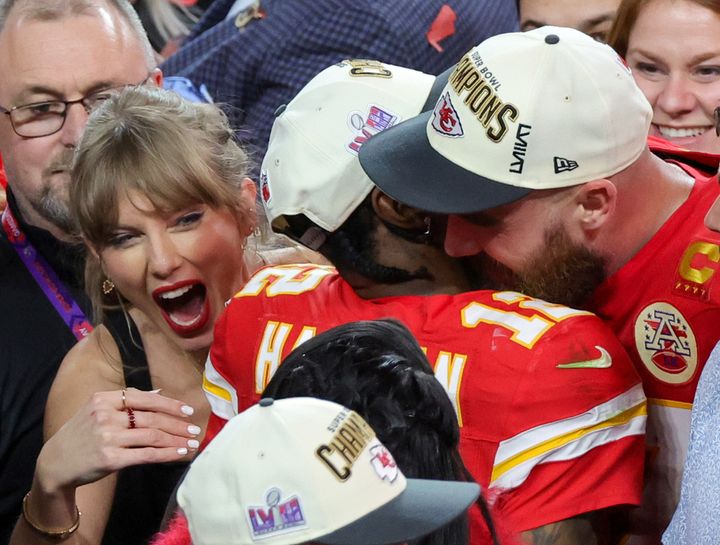 Taylor Swift, Mecole Hardman Jr. and Travis Kelce photographed celebrating the Chiefs' 25-22 overtime victory over the San Francisco 49ers in Super Bowl LVIII at Allegiant Stadium on February 11, 2024 in Las Vegas, Nevada.