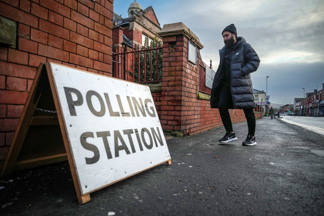 A voter arrives at a polling station in the Rochdale by-election.