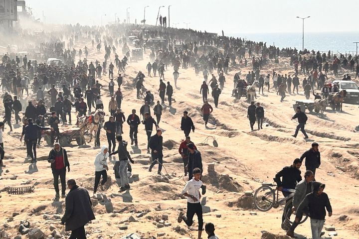 Palestinians wait for humanitarian aid on a beachfront in Gaza City, Gaza Strip, on Feb. 25, 2024. 