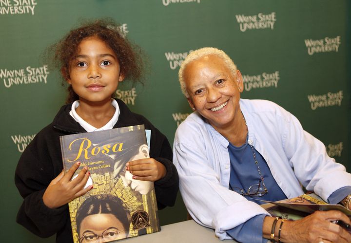 Nikki Giovanni poses with a smiling young fan at a 2010 book signing of "Rosa," the banned children's book detailing the story of late activist Rosa Parks. The book is among the many titles mentioned in "The ABCs of Book Banning."