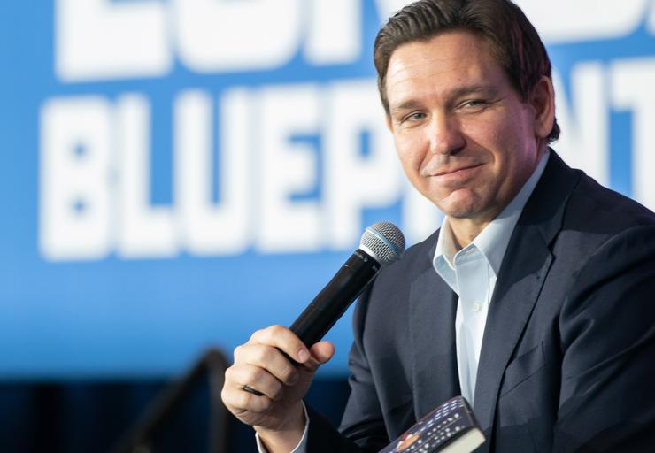Florida Gov. Ron DeSantis speaks at a South Carolina event while holding his own book, “The Courage to Be Free,” which isn’t on the banned list. 