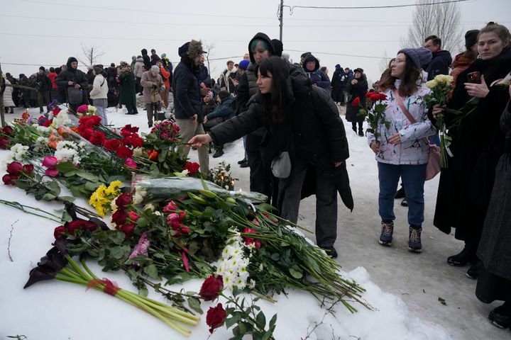 People lay flowers paying the last respect to Alexei Navalny, in a street not far from the Borisovskoye Cemetery in Moscow, Russia, on March 1, 2024.