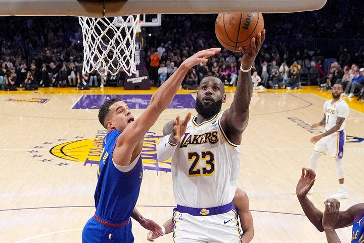 Los Angeles Lakers forward LeBron James, right, scores as Denver Nuggets forward Michael Porter Jr., defends, becoming the first NBA player to reach 40,000 points in a career, during the first half of an NBA basketball game Saturday, March 2, 2024, in Los Angeles. (AP Photo/Mark J. Terrill)