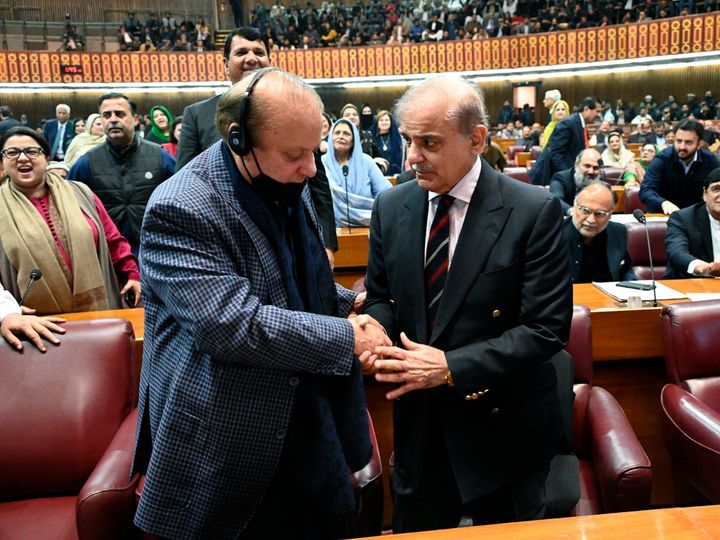 In this photo released by the National Assembly office, Pakistan's newly elected Prime Minister Shehbaz Sharif, foreground right, is congratulated by his elder brother and former Prime Minister Nawaz Sharif following his appointment, at a parliament session, in Islamabad, Pakistan, Sunday, March 3, 2024. Lawmakers in Pakistan's National Assembly elected Sunday Shehbaz Sharif as the country's new prime minister for the second time as allies of imprisoned former premier Imran Khan in parliament shouted in protest, alleging rigging in last month's election. (National Assembly Office via AP)