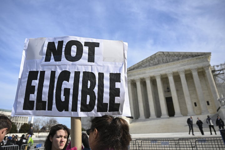 Demonstrators hold "Trump is a traitor" banners outside the US Supreme Court during the hearing in Washington, United States on February 8, 2024.(Photo by Celal Gunes/Anadolu via Getty Images)