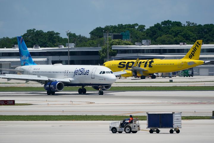 FILE - A JetBlue Airways Airbus A320, left, passes a Spirit Airlines Airbus A320 as it taxis on the runway, July 7, 2022, at the Fort Lauderdale-Hollywood International Airport in Fort Lauderdale, Fla. (AP Photo/Wilfredo Lee, File)