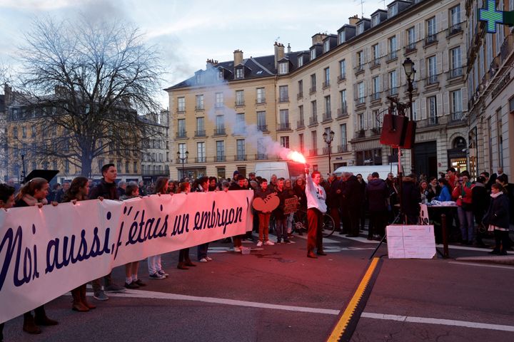 Protesters hold a banner reading "I was an embryo too" during a demonstration against abortion and euthanasia in Versailles on Monday.