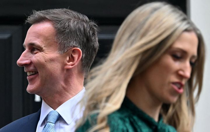 Chief Secretary to the Treasury Laura Trott walks past Jeremy Hunt as he leaves 11 Downing Street to deliver the Budget.