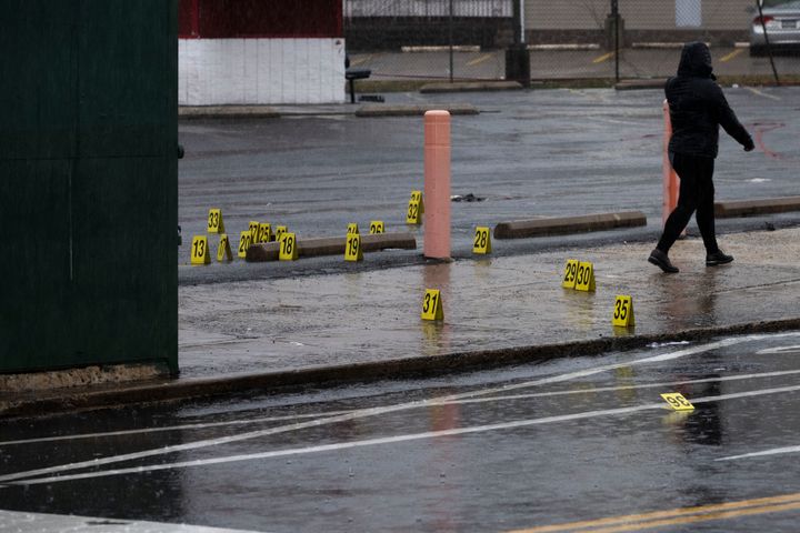 Evidence markers dot the ground following a shooting in northeast Philadelphia on Wednesday. Four shootings over four days in Philadelphia have left at least three dead and 12 injured, many of them children.