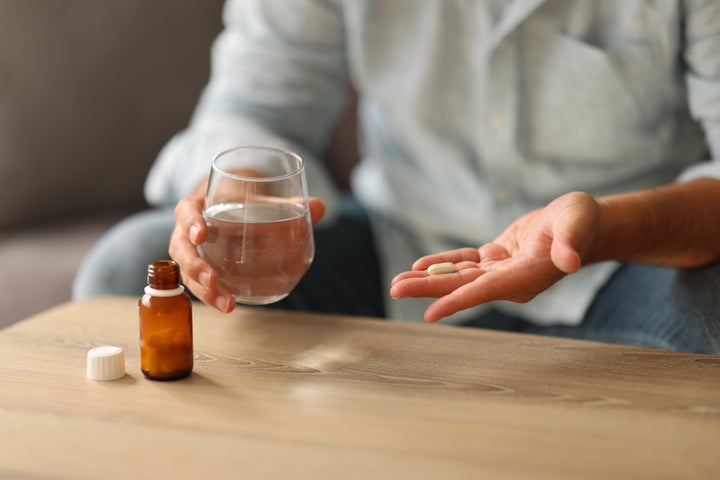 Man taking medicine.