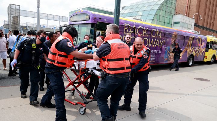 A victim of the boat accident is rushed away by paramedics.