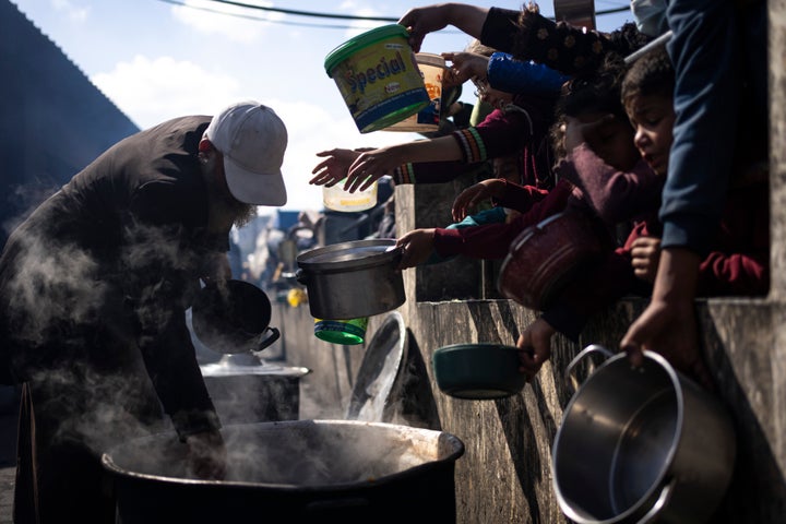 FILE - Palestinians line up for a free meal in Rafah, Gaza Strip, Friday, Feb. 16, 2024.(AP Photo/Fatima Shbair, File)