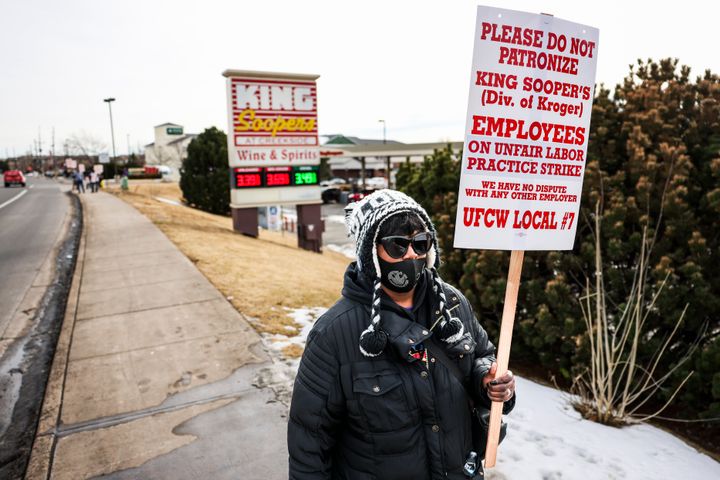 A worker at King Soopers, which is owned by Kroger, walks the picket line during a strike in Glendale, Colorado, in Jan. 2022. Kroger and Albertsons have mostly unionized workforces.