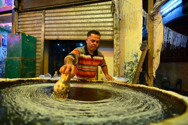 A man makes kunafa, an Egyptian dish usually made during the holy month of Ramadan on March 9, 2024 in Giza, Egypt. Ramadan in Egypt is expected to take place from Sunday evening on March 10th until April 8th.