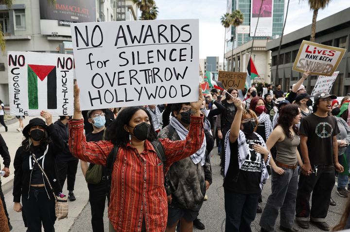 Protesters demand an immediate and permanent cease-fire, and an end to the blockade of Gaza and the occupation of Palestine in Oscar Rally and March in Hollywood on Sunday in Los Angeles, California.