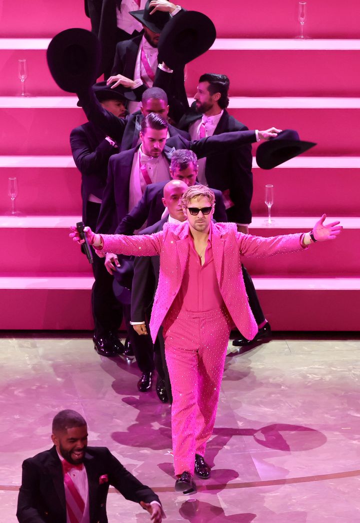 Gosling wore a hot pink suit and sunglasses. 