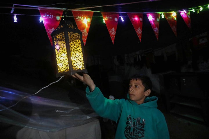 Displaced Palestinians decorate their tent in preparation for the holy month of Ramadan on March 10, 2024, in Rafah, Gaza.