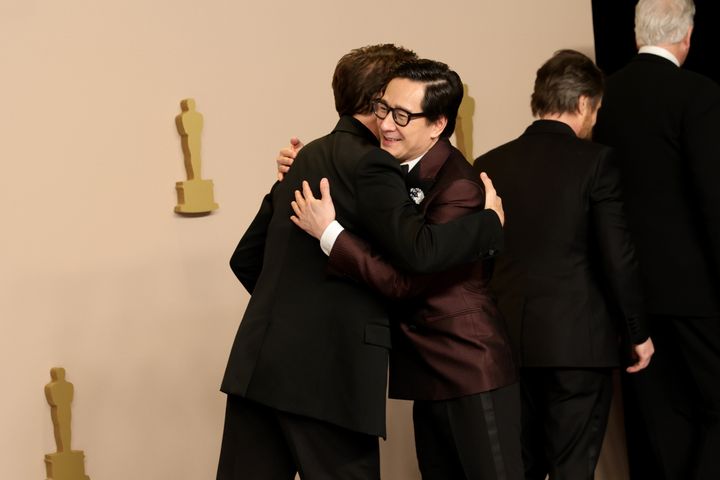 Robert Downey Jr., winner of the Best Actor in a Supporting Role award for “Oppenheimer,” and presenter Ke Huy Quan hug in the press room during the 96th Academy Awards Sunday.