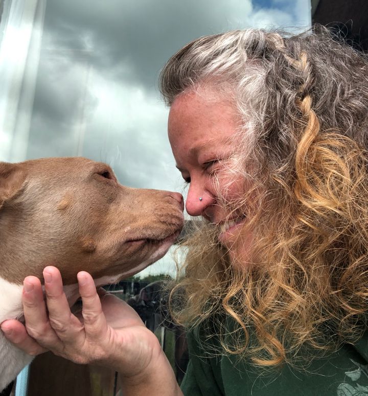 "Here I am growing out my gray and smooching my special needs rescue pup, Sissy," the author writes.