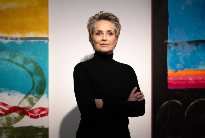 Sharon Stone stands among her paintings at the Deschler Gallery in Berlin in February.
