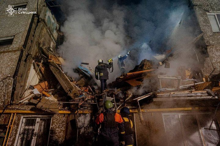 In this photo provided by the Ukrainian Emergency Service on March 13, 2024, emergency services personnel work at an apartment building destroyed by a Russian attack in Sumy, Ukraine.