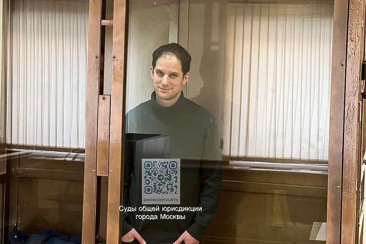 Gershkovich stands in a glass cell in a courtroom at the Moscow City Court on Feb. 20, 2024.