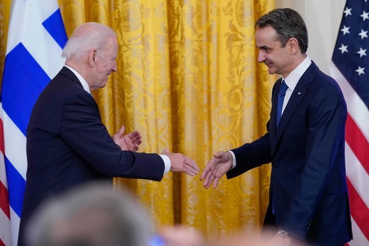 President Joe Biden and Greek Prime Minister Kyriakos Mitsotakis shake hands as they attend a reception in the East Room of the White House in Washington, Monday, May 16, 2022. (AP Photo/Susan Walsh)