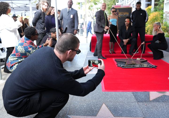 Tatum seen taking a photo of Zoë Kravitz, Lenny Kravitz, Denzel Washington and host Sibley Scoles at the ceremony honoring Lenny Kravitz with a star on the Hollywood Walk of Fame.