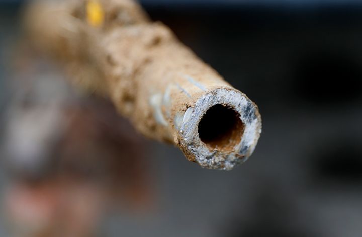 FILE - In this July 20, 2018, file photo, a lead pipe is shown after being replaced by a copper water supply line to a home in Flint, Mich. Gov. Gretchen Whitmer announced a $500 million plan Thursday, Oct. 1, 2020, to upgrade drinking water and wastewater infrastructure in Michigan with actions such as replacing lead service lines and removing chemical pollutants. (AP Photo/Paul Sancya, File)