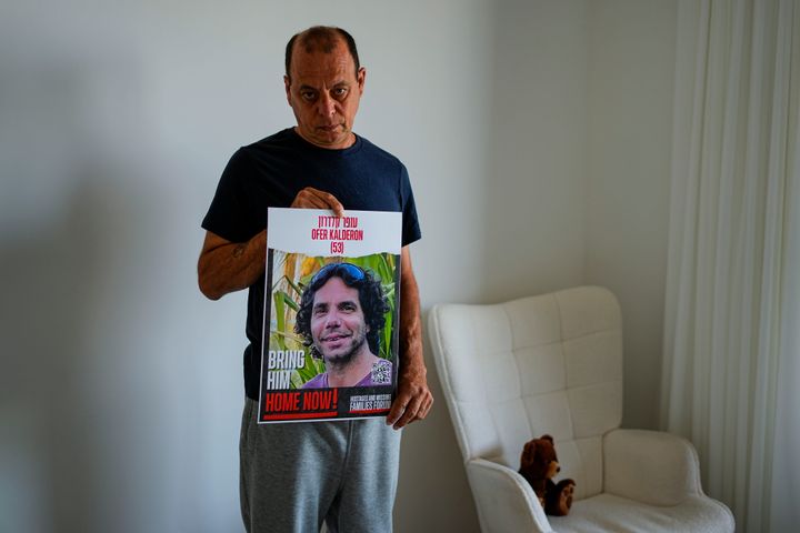 Nissan Kalderon poses in the Israeli city of Ramat Gan with a photo of his only brother, Ofer, a hostage held in the Gaza Strip by Hamas, on Wednesday, March 13, 2024. With each passing day, the relatives of hostages in Gaza face a deepening despair.
