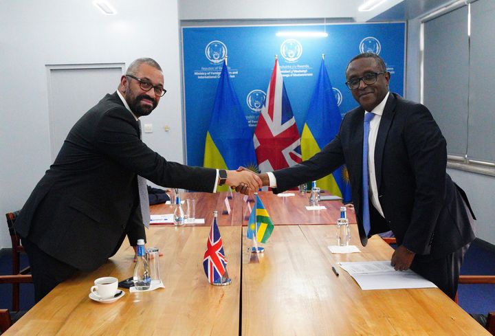 Home Secretary James Cleverly and Rwandan Minister of Foreign Affairs Vincent Biruta shake hands at bilateral meeting after they signed a new treaty in Kigali, Rwanda, Tuesday, Dec. 5, 2023. The treaty will address concerns by the Supreme Court, including assurances that Rwanda will not remove anybody transferred under the partnership to another country. (Ben Birchall/PA Wire via AP)