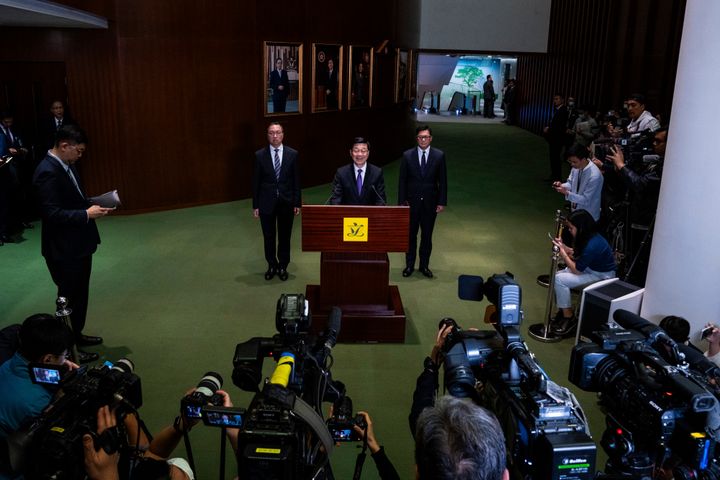 Hong Kong's Chief Executive John Lee, center, Secretary for Justice Paul Lam, centre left, and Secretary for Security Chris Tang, centre right, attend a press conference following the passing of the Basic Law Article 23 legislation at the Legislative Council in Hong Kong, Tuesday, March 19, 2024. (AP Photo/Louise Delmotte)