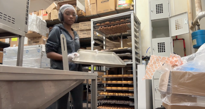 Delaya Lowery prepares donut orders on her overnight shift.