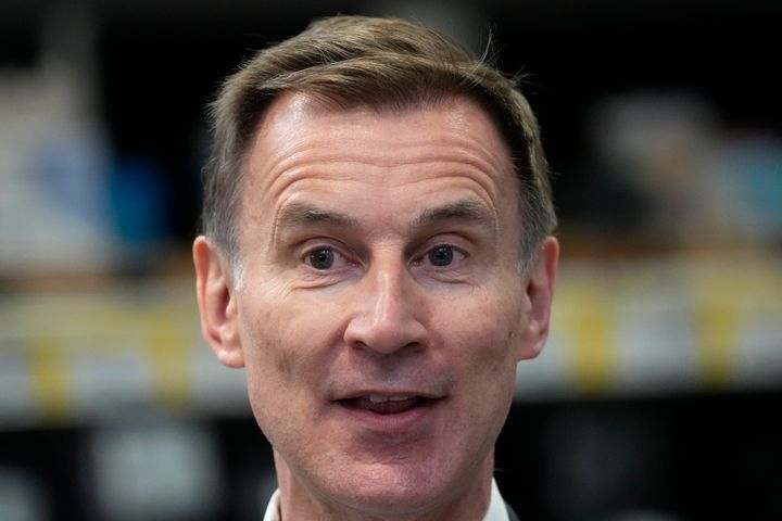 Britain's Chancellor Jeremy Hunt speaks to a Tv reporter during a visit to a builders warehouse in London, Wednesday, March 6, 2024. The Chancellor earlier Wednesday delivered the annual Budget to the House of Commons . (AP Photo/Kirsty Wigglesworth, pool)