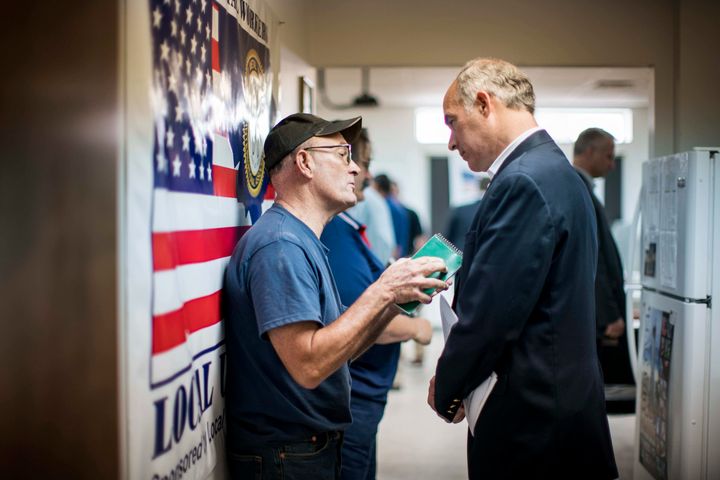 Sen. Bob Casey (D-Pa.) talks to a Sheet Metal Workers union member after a forum on trade policy in Wilkes-Barre in August 2017. He has been a trade policy populist.