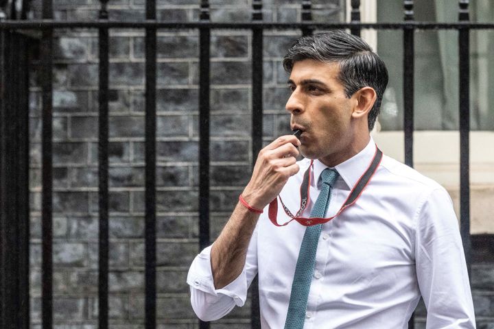 Rishi Sunak blows a whistle during a football coaching event in Downing Street.